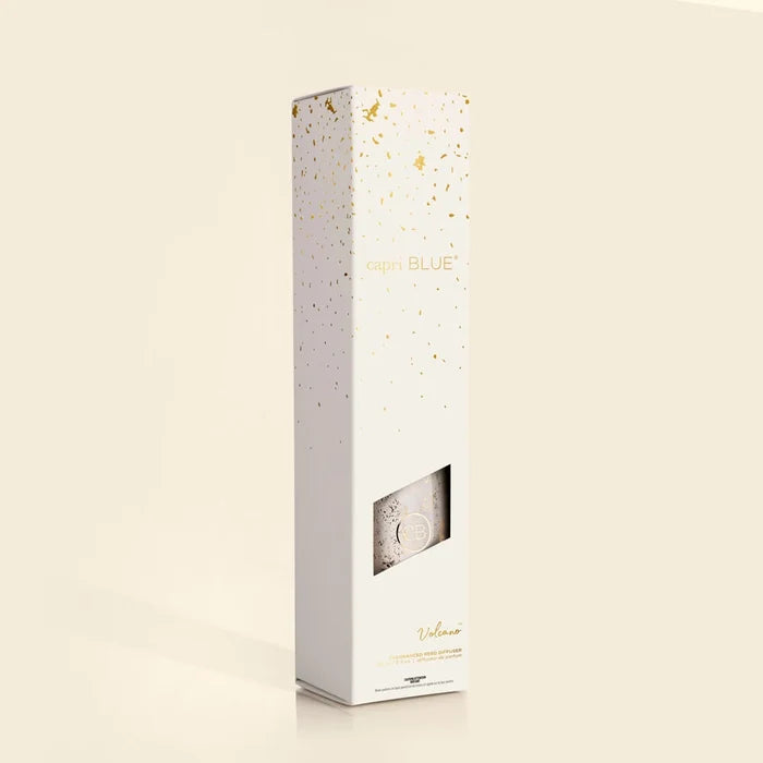 a capri blue volcano reed diffuser displayed in box against a beige background