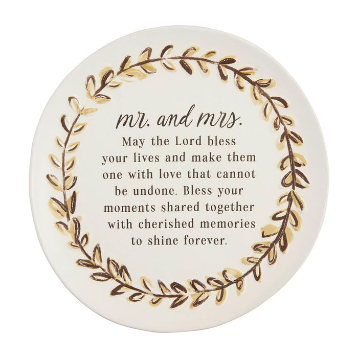 Round decorative item with 'Mr. and Mrs.' text and floral design on a white background