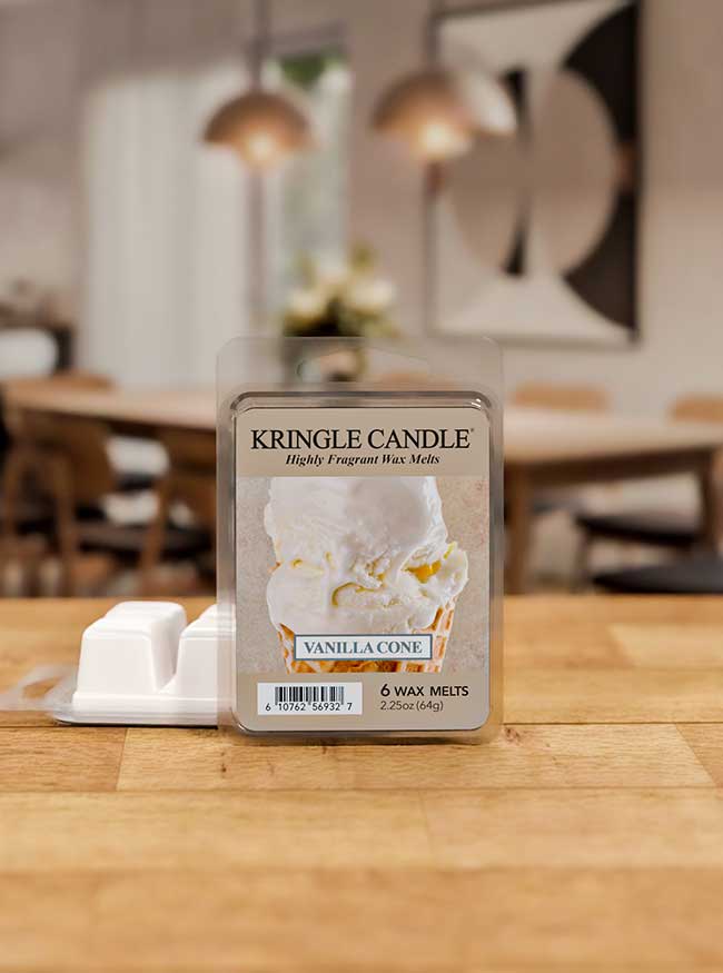 Kringle Candle Vanilla Cone wax melts packaging on a wooden table with a blurred indoor background