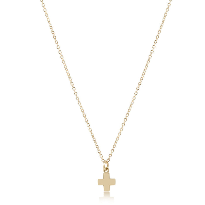 Gold necklace with a small cross pendant on a white background
