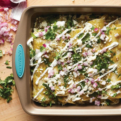 A baking dish of enchiladas topped with cheese, onions, and cilantro becomes even more delightful when prepared in the 2-Piece 9-Inch Nonstick Square Cake Pans.