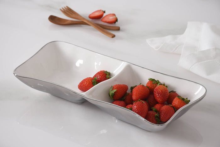 White ceramic dish with strawberries on a white surface