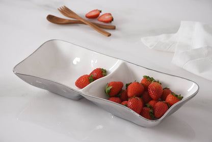 White ceramic dish with strawberries on a white surface