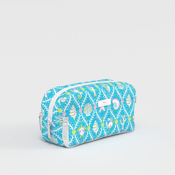 Blue toiletry bag with colorful pattern on a light gray background