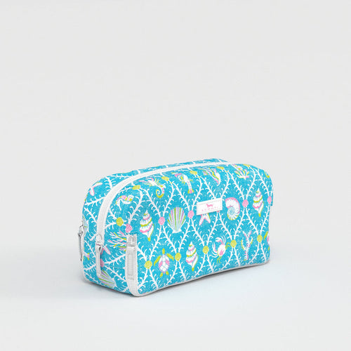 Blue toiletry bag with colorful pattern on a light gray background