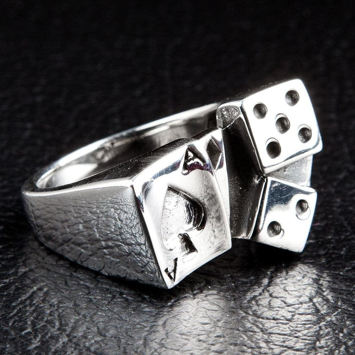 Handcrafted 925 silver poker ring with ace and dice detail photographed on black leather surface