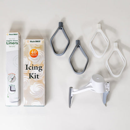 NutriMill bakers bundle including: cookie sheet liners, icing kit, pro line cookie paddles, cake paddles, and bowl scraper on grey background