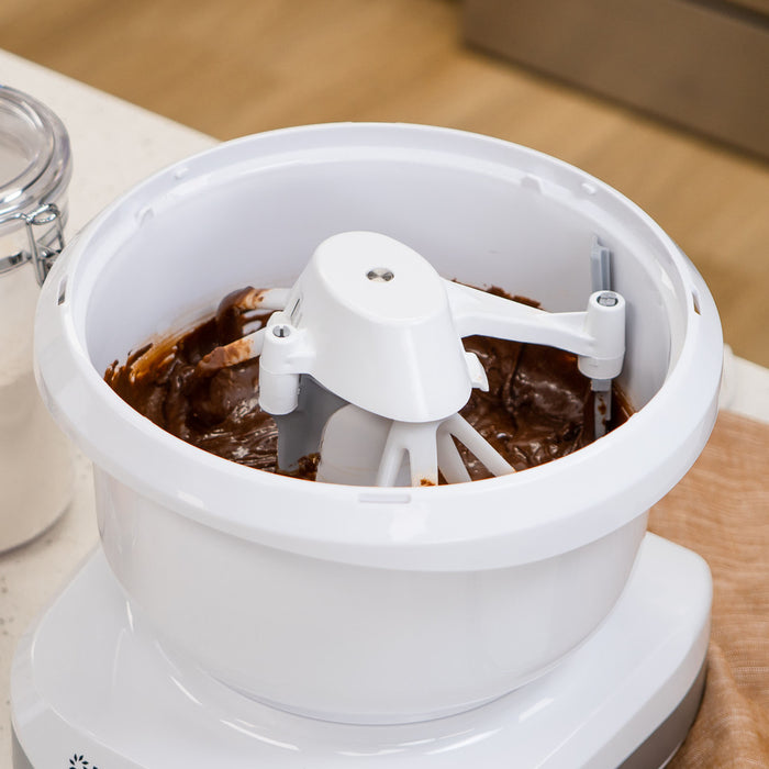 NutriMill artiste mixer mixing brown batter with the NutriMill cake paddles and bowl scraper