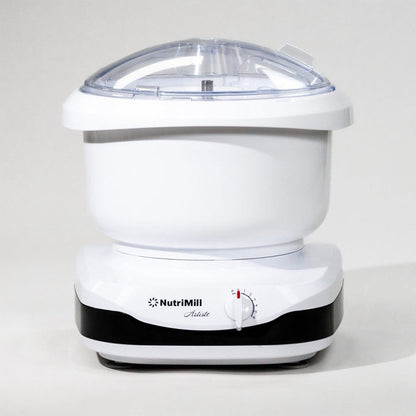 White NutriMill Artiste mixer with black trim in front of grey background