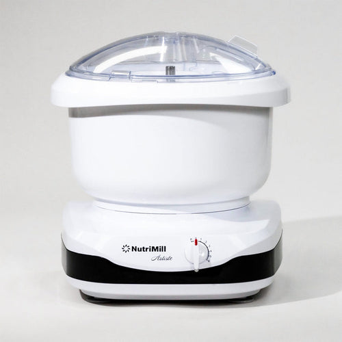 White NutriMill Artiste mixer with black trim in front of grey background