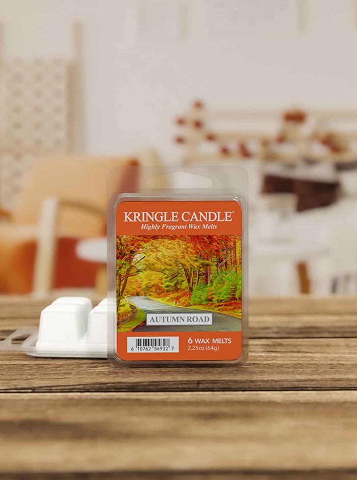 Kringle Candle Autumn Road wax melt package on a wooden surface with a blurred background