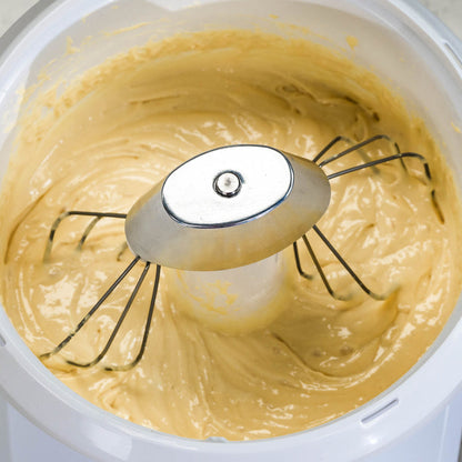 Bosch batter whisks attached to a NutriMill metal whip driver mixing yellow batter