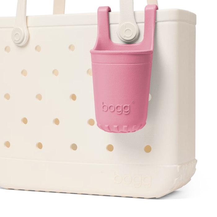 White tote bag with gold polka dots and a pink bogg bag holder on a white background