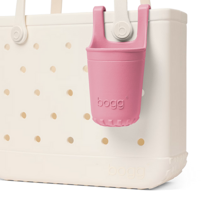 White tote bag with gold polka dots and a pink bogg bag holder on a white background