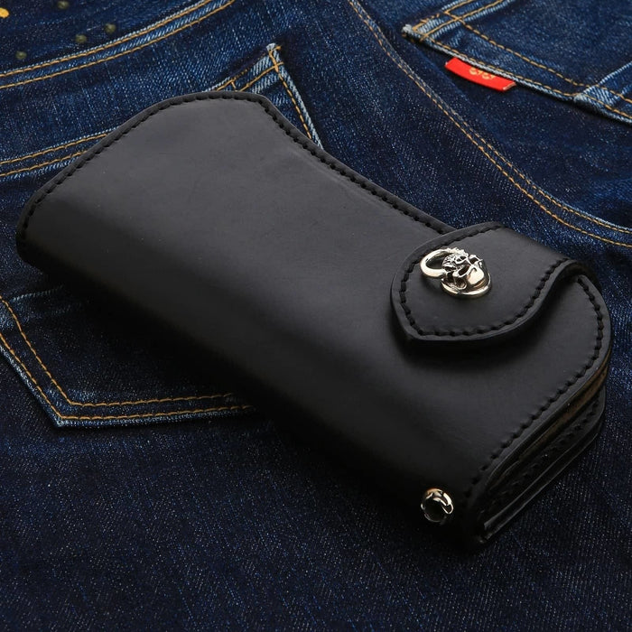 The solid sterling silver skull concho on a rugged, black leather biker wallet.
