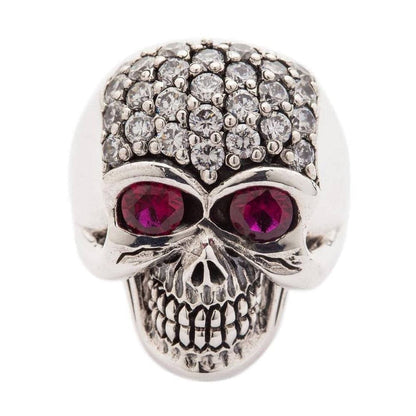 A solid sterling silver bling women's skull ring, featuring a pavé crystal cranium and large, deep red stone eyes.