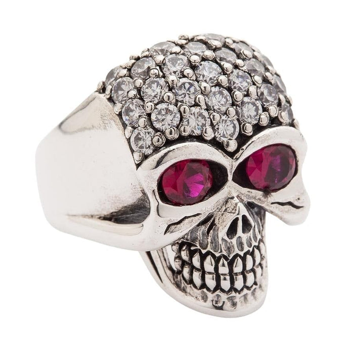 A stunning iced-out skull ring featuring dozens of clear, brilliant CZ stones and two large red eye stones for a dramatic look.