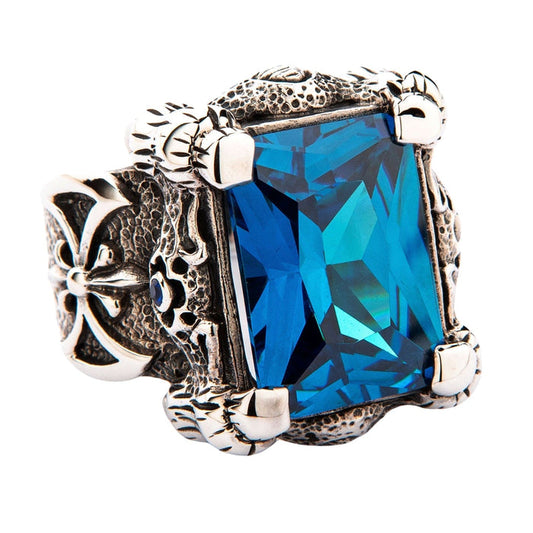 A gothic-style sterling silver dragon claw ring, featuring a rugged, scaly band and a 36-carat blue topaz CZ stone.