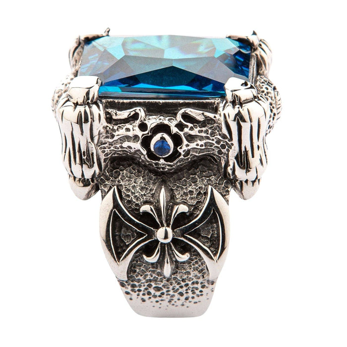 A gothic dragon ring with a huge blue stone, featuring intricate scale details and a warrior's axe emblem.