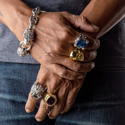 A model's hand wearing the colossal blue topaz dragon claw ring to demonstrate its massive and impressive scale.