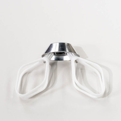 NutriMill cake paddles attached to a metal whip driver on a grey background