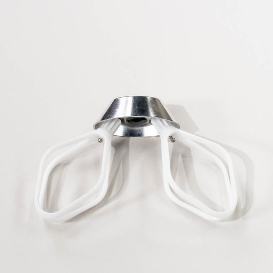 NutriMill cake paddles attached to a metal whip driver on a grey background