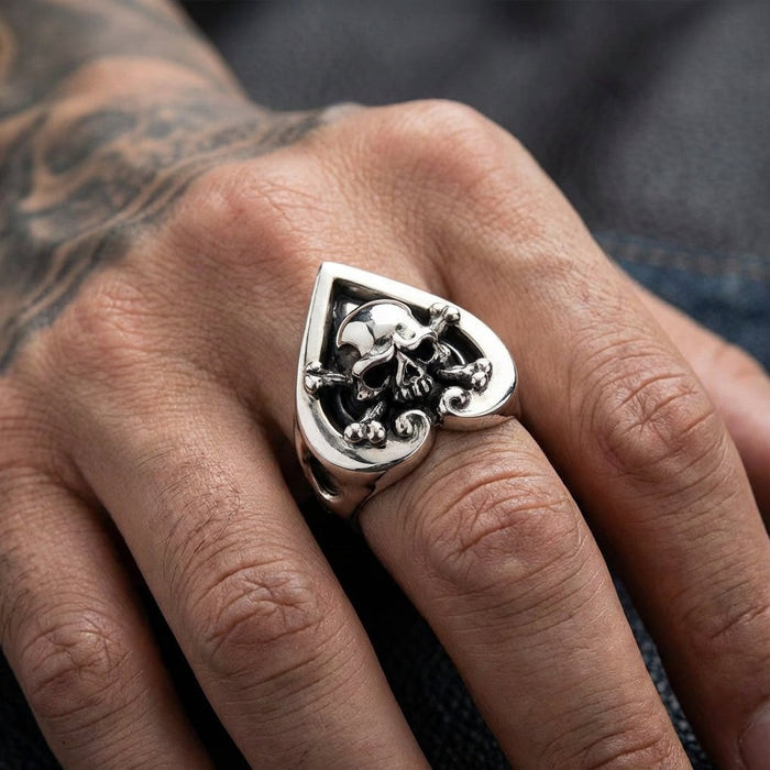Model wearing the crossbones heart ace ring on index finger
