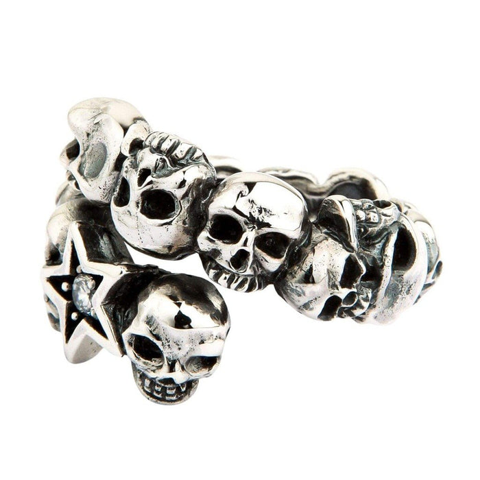 Bypass design of the .925 silver band showing the gap between the jeweled star and carved skull terminals on white.