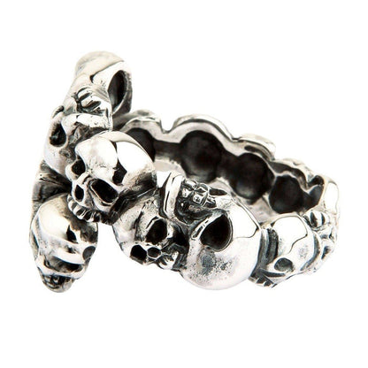 Elevated side angle highlighting the stacked skull ends of the .925 silver wrap band and its hollow inner structure.