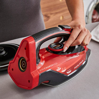 Red and black iron with 'Morphy Richards' branding on a gray surface.