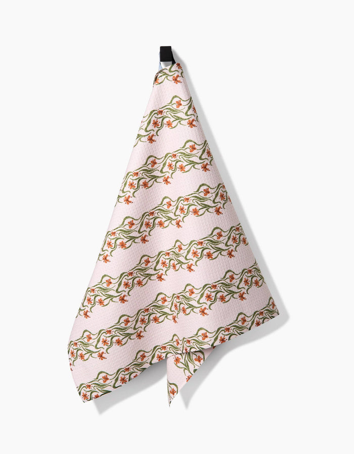 Floral patterned towel hanging on a white background