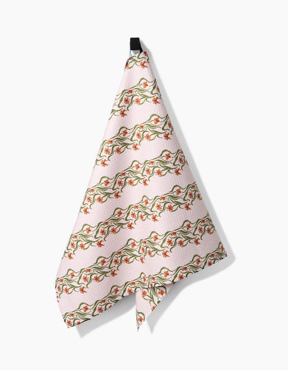 Floral patterned towel hanging on a white background