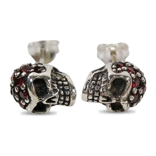 Garnet head skull stud earrings in .925 sterling silver, front pair view with red garnets pavé-set across each crown