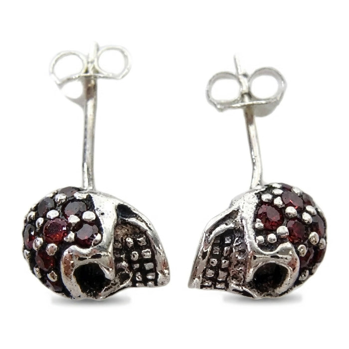 Top-down view of the natural garnet pavé crowns on both skull studs with posts and butterfly backs upright