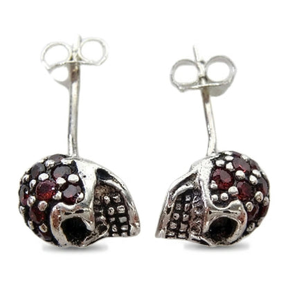 Top-down view of the natural garnet pavé crowns on both skull studs with posts and butterfly backs upright