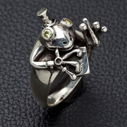 Side view of silver frog ring showing detailed webbed feet and top hat design