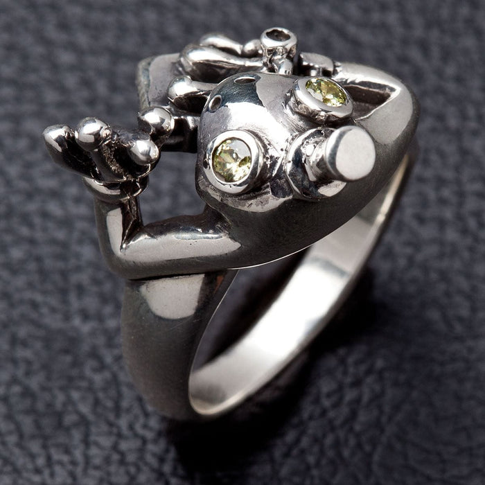 Angled view of detailed polished silver texture on frog ring