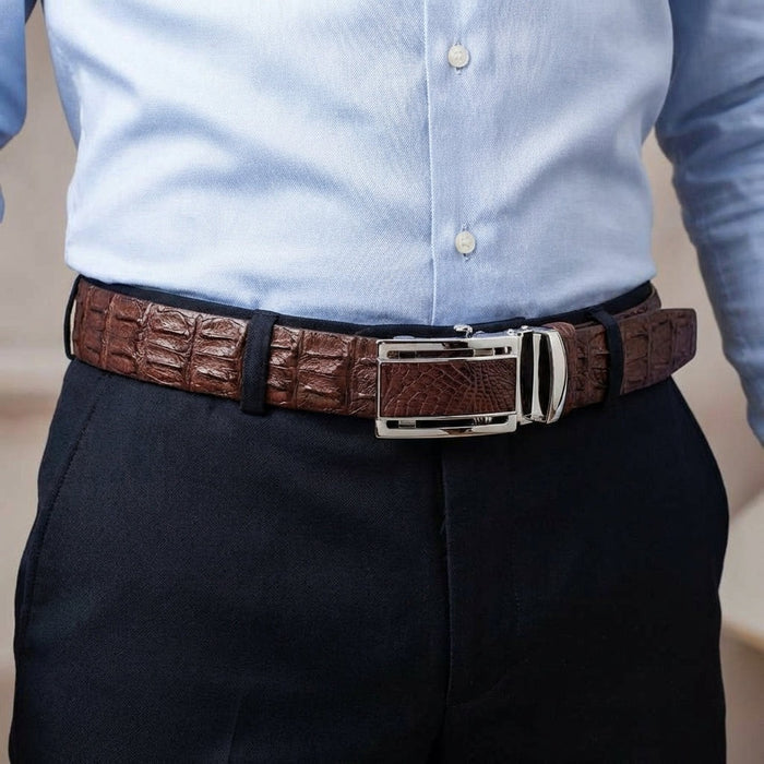 Mens genuine crocodile leather belt worn with navy dress pants and blue shirt