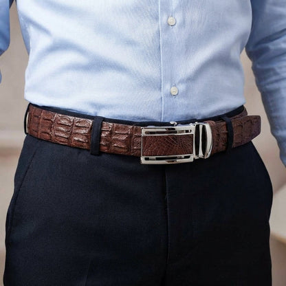 Mens genuine crocodile leather belt worn with navy dress pants and blue shirt