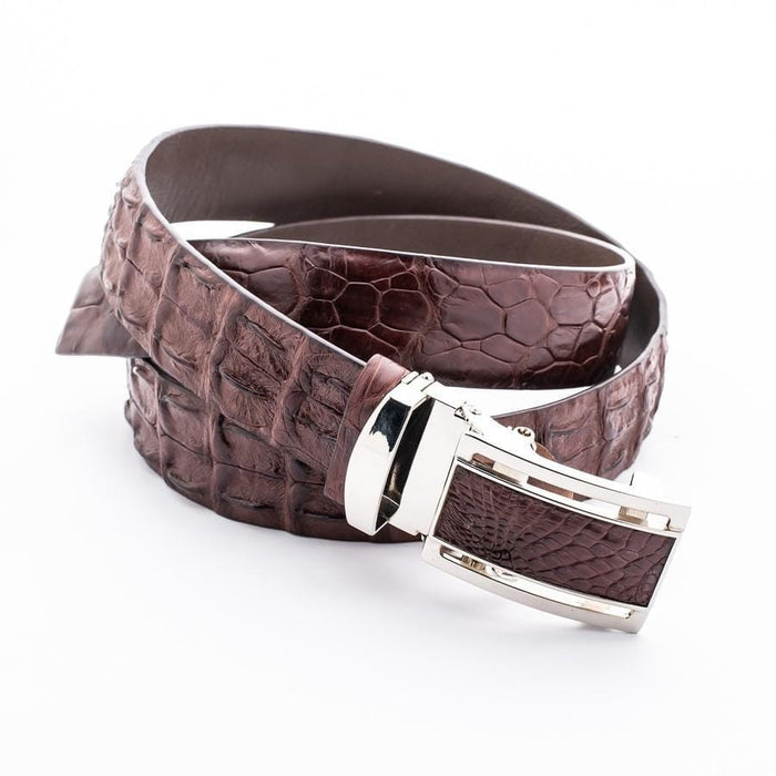 Crocodile skin belt rolled displaying natural leather texture and silver buckle