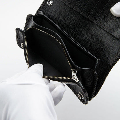 Gloved hands pulling open the silver-zippered pouch to reveal the deep fabric-lined interior compartment.