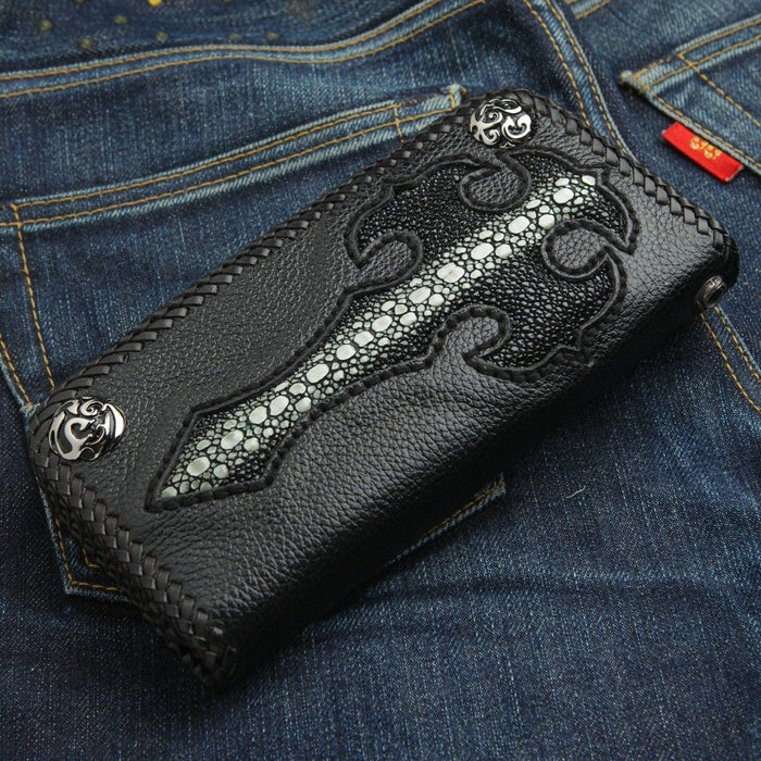 Angled across a blue jean pocket, the black pebbled leather wallet highlights its distinct beaded stingray cross center.