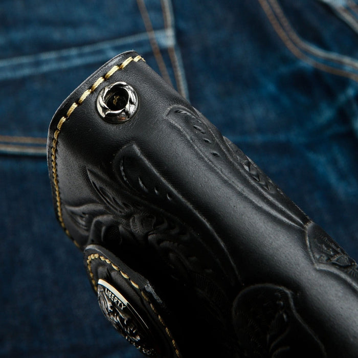 The solid sterling silver grommet for a wallet chain attachment on the hand-tooled leather wallet.