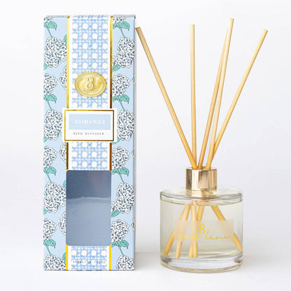 Reed diffuser with floral packaging on a white background