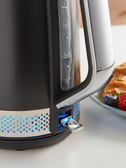 Black electric kettle with blue LED lights on a white surface