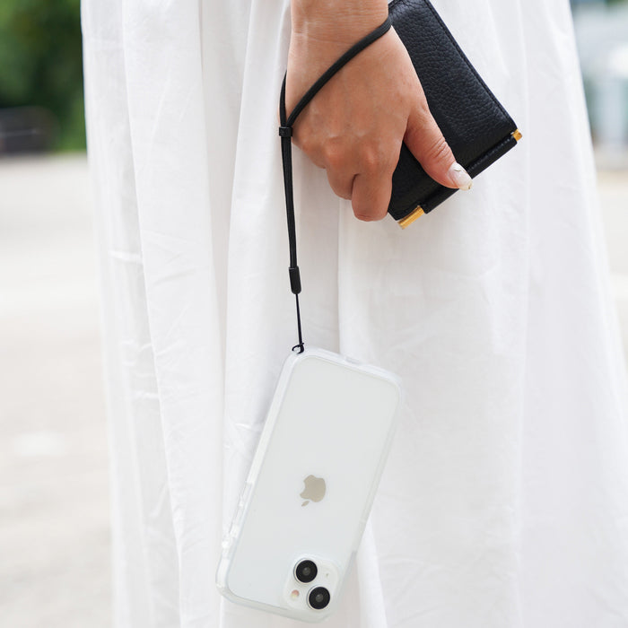 Catalyst iphone 15 series influence case iphone 15 in clear colorway hanging from hand with lanyard attached