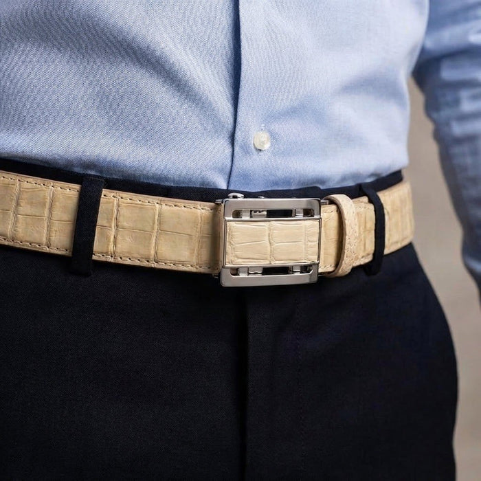 Lifestyle shot showing the genuine stomach crocodile strap worn with navy trousers and a light blue dress shirt.