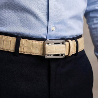 Lifestyle shot showing the genuine stomach crocodile strap worn with navy trousers and a light blue dress shirt.