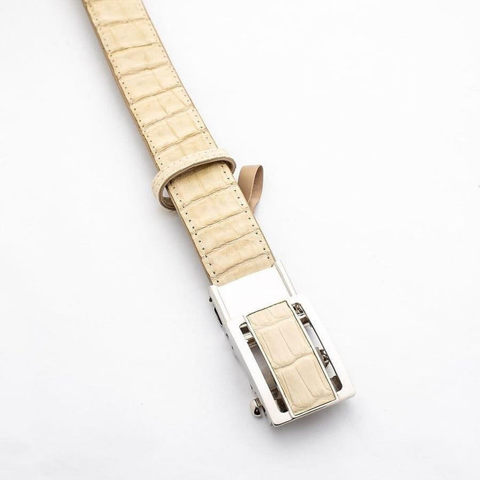 Close-up of the polished silver-tone buckle featuring a matching cream crocodile scale inlay.