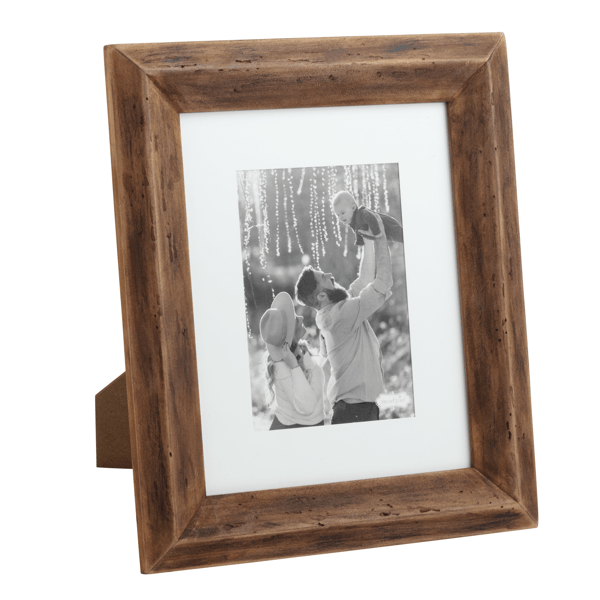 Wooden picture frame with a photo of a couple and child inside on a white background